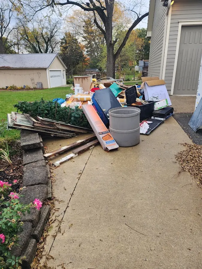 Dumpster being loaded with debris for 10 Yard Dumpster Rental in Groveland